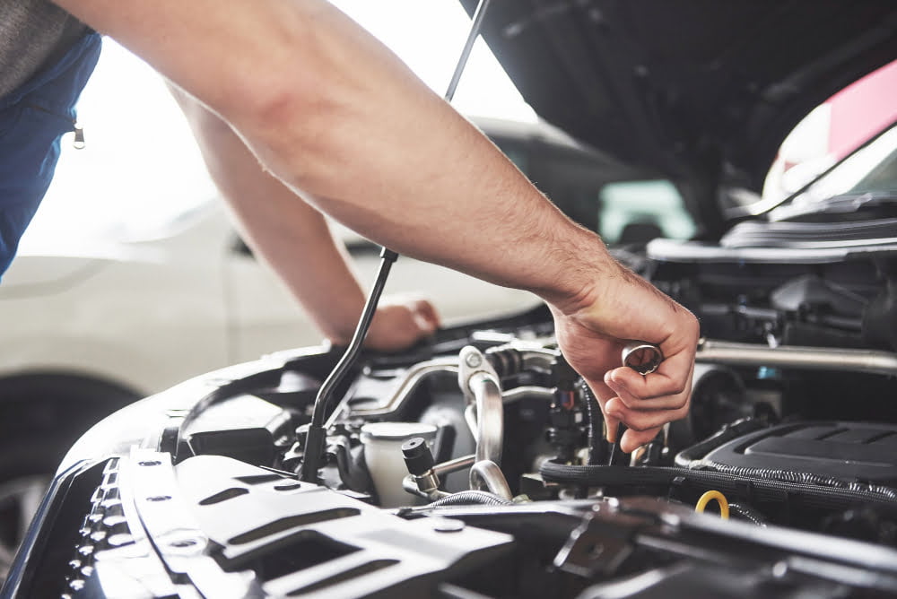 close up hands unrecognizable mechanic doing car service maintenance 1