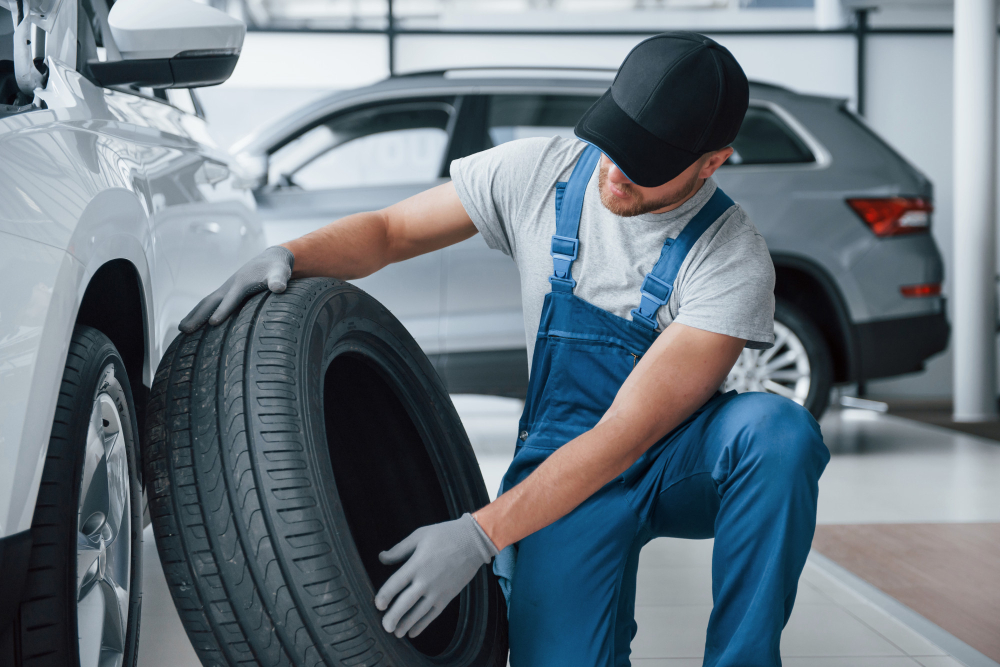 fresh material mechanic holding tire repair garage replacement winter summer tires
