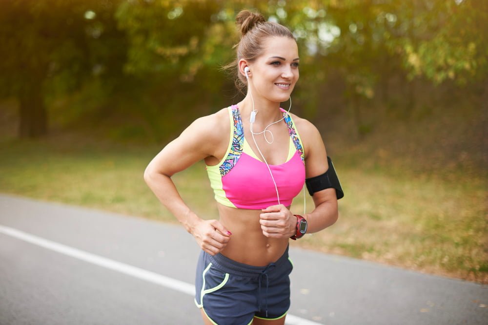 young woman exercising outdoor summer helps getting motivation